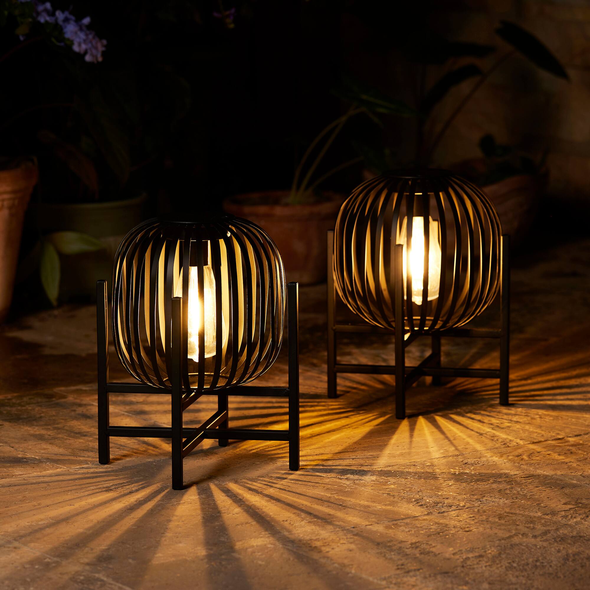 Glitzhome® 11.5" Black Slim Metal Stripes Solar Powered Edison Bulb Outdoor Lantern, 2ct.